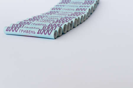 Ukrainian hryvnia. Money in rolls on a white with a place for text.
