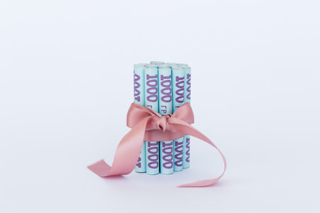Ukrainian 1000 hryvnia in a roll with a gift ribbon.の写真素材