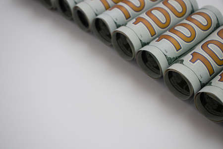 Rolled 100 dollars on white with copy space. American money.の写真素材