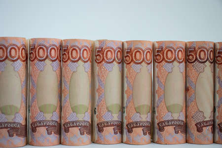 Russian money folded are in a raw on a white background.の写真素材