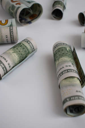 Rolled dollars on a white with copy space. American money.の写真素材