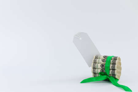100 dollar bills tied with green gift ribbon and white blank for notes. Mock up.の写真素材