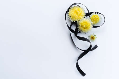Decoration from black funeral ribbon with yellow flowers.の写真素材