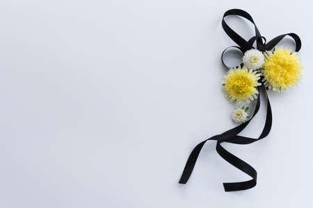 Decoration from black funeral ribbon with yellow flowers.の写真素材