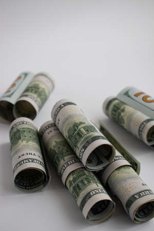 Rolled dollars on a white with copy space. American money.の写真素材
