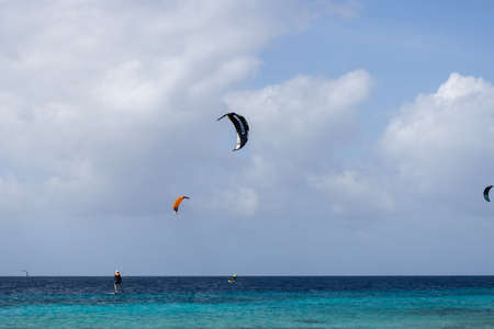 Unrecognisable people practicing kiteboarding. Active sport in summertime.の写真素材