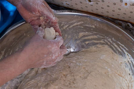 Womans hands with dough. Closeup, selective focus.の写真素材