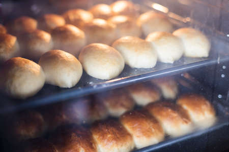 Pies in oven. View through the glass. Closeup, selective focus.の写真素材