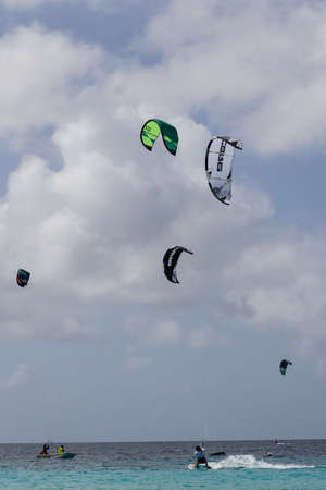 Unrecognisable people practicing kiteboarding. Active sport in summertime.の写真素材