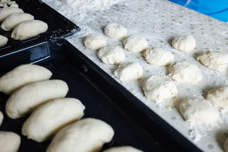 The dough for pies on the kitchen table. Baking at home.の写真素材