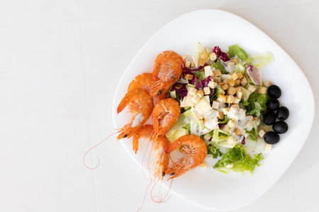 Shrimps with salad on a white plate.の写真素材