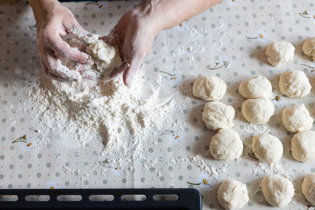 Womans hands rolling the dough for pies. Baking at home