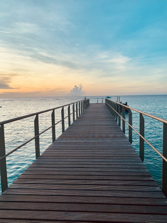 Wooden pier at sunset. Seascape with sunset lights.の写真素材