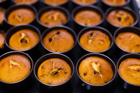 Fresh bakery. Cupcakes just form oven in cookie cutters. Selective focus.