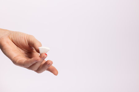 Woman finger with blood drop for test. Finger with drop of blood on white background with copy space, close-up.の写真素材