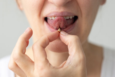 Woman with piercing on the tongue with plaque on the surface of jewellery. Oral care concept.の写真素材