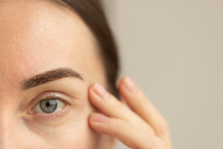 Female eyebrow after permanent makeup one week. Healing eyebrows. Closeup.