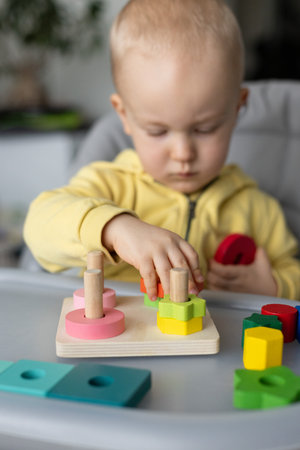 Little kid playing with educational toy, Cognitive skills, Montessori activity. Closeup, selective focus.の写真素材