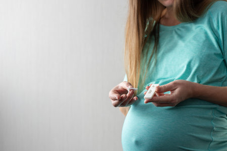 Pregnant woman made a rapid test for HIV and waiting for results.の写真素材