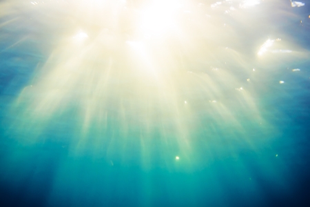 Texture of blue water in tropical ocean and sunlight. Underwater blue backgroundの写真素材