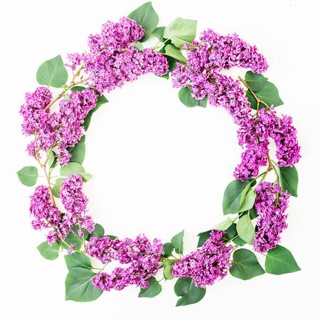 Round floral frame of lilac branches and leaves on white background. Flat lay, top view. Summer patternの写真素材