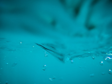 Bubbles in tropical ocean. Underwater waves texture in sea