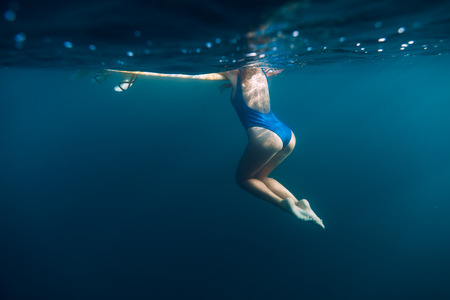 Underwater woman with blue bikini in the oceanの写真素材