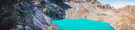 Panorama of beautiful mountain lake with turquoise water and rocky mountainsの写真素材