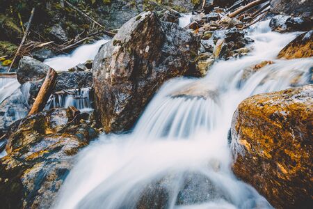 Waterfall and mountain river with rocks