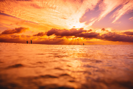 Stand up paddle board, quiet sea with warm sunset or sunrise colors. Relaxing on oceanの写真素材