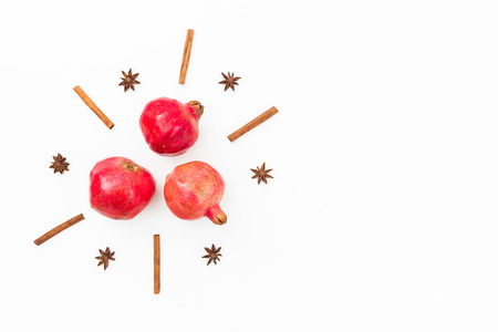 Delicious garnet, cinnamon and anise on white background. New year concept. Flat lay. Top viewの写真素材