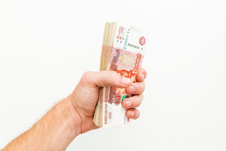 Russian banknotes 5000 rubles in men hand on white background. One million.の写真素材