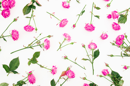 Floral pattern with pink roses, branches and leaves on white background. Flat lay, Top view. Roses textureの写真素材