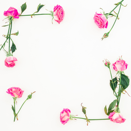 Floral frame of pink roses and buds on white background. Flat lay, Top view.の写真素材