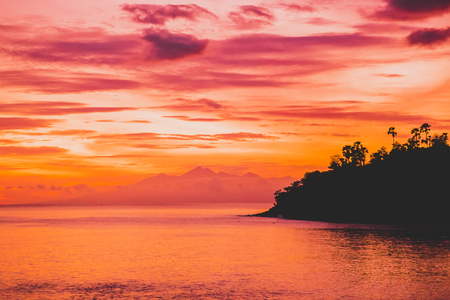 Ocean at bright sunset or sunrise in the ocean. Sea with warm sunset colorsの写真素材