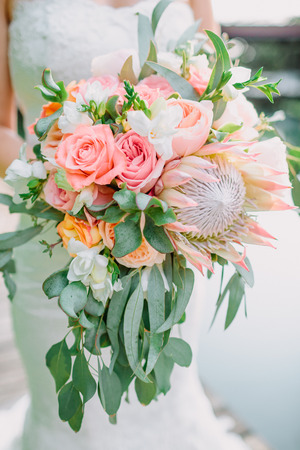Bride holds a bouquet with proteus and roses. Wedding dayの写真素材