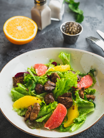 Tasty salad with citrus, lettuce and grilled chicken.の写真素材