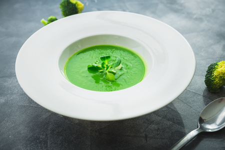 Homemade spinach soup in a bowl on a gray backgroundの写真素材