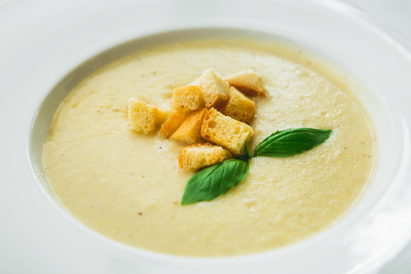 Homemade tasty pea soup with grilled bread in a bowlの写真素材