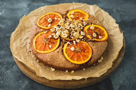 Tasty pie with citrus and nuts on board. Closeup view.の写真素材