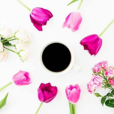 Composition with tulips, roses and mug of coffee on white background. Blogger concept. Flat lay, top view.の写真素材