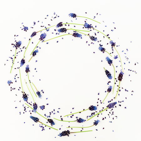 Floral round pattern with blue flowers and pink hyacinth flower on white background. Flat lay, top view.の写真素材
