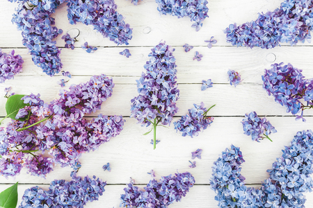 Floral composition with lilac flowers on wooden background. Flat lay, top view.の写真素材