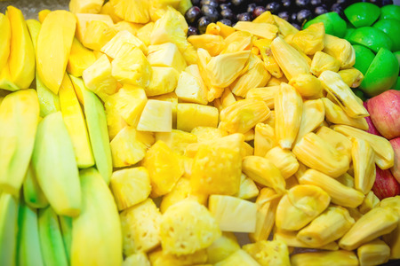 Tropical fruits in the market. Mango, pineapple, jackfruit and apple.の写真素材