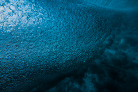 Underwater barrel wave in tropical ocean in Oahu. Wave texture in oceanの写真素材
