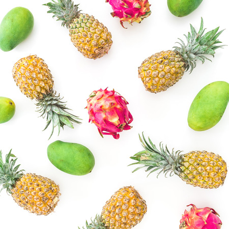Pattern of pineapple, mango and dragon fruits on white background. Flat lay, top view. Food background.の写真素材