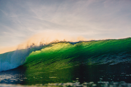 Big barrel wave in the ocean. Green wave after sunsetの写真素材
