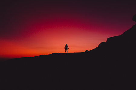 Bright colorful sunset or sunrise and silhouette of peopleの写真素材