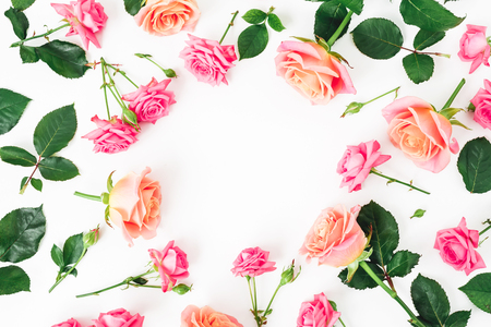 Floral round frame with roses flowers, petals and leaves on white background. Flat lay, top view.の写真素材