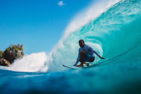 July 7, 2018. Bali, Indonesia. Surfer ride on a big barrel wave at Padang Padang. Professional...